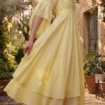 Woman wearing Elara Butter Yellow Cotton Flared Midi Dress by Jivaraa