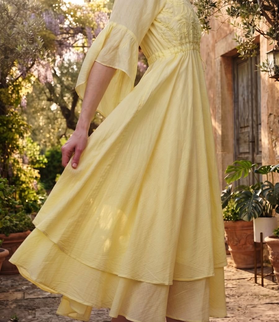 Woman wearing Elara Butter Yellow Cotton Flared Midi Dress by Jivaraa