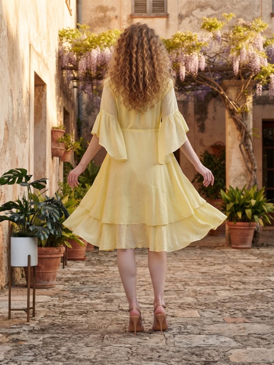 Woman wearing Elara Butter Yellow Cotton Flared Midi Dress by Jivaraa