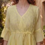 Woman wearing Elara Butter Yellow Cotton Flared Midi Dress by Jivaraa